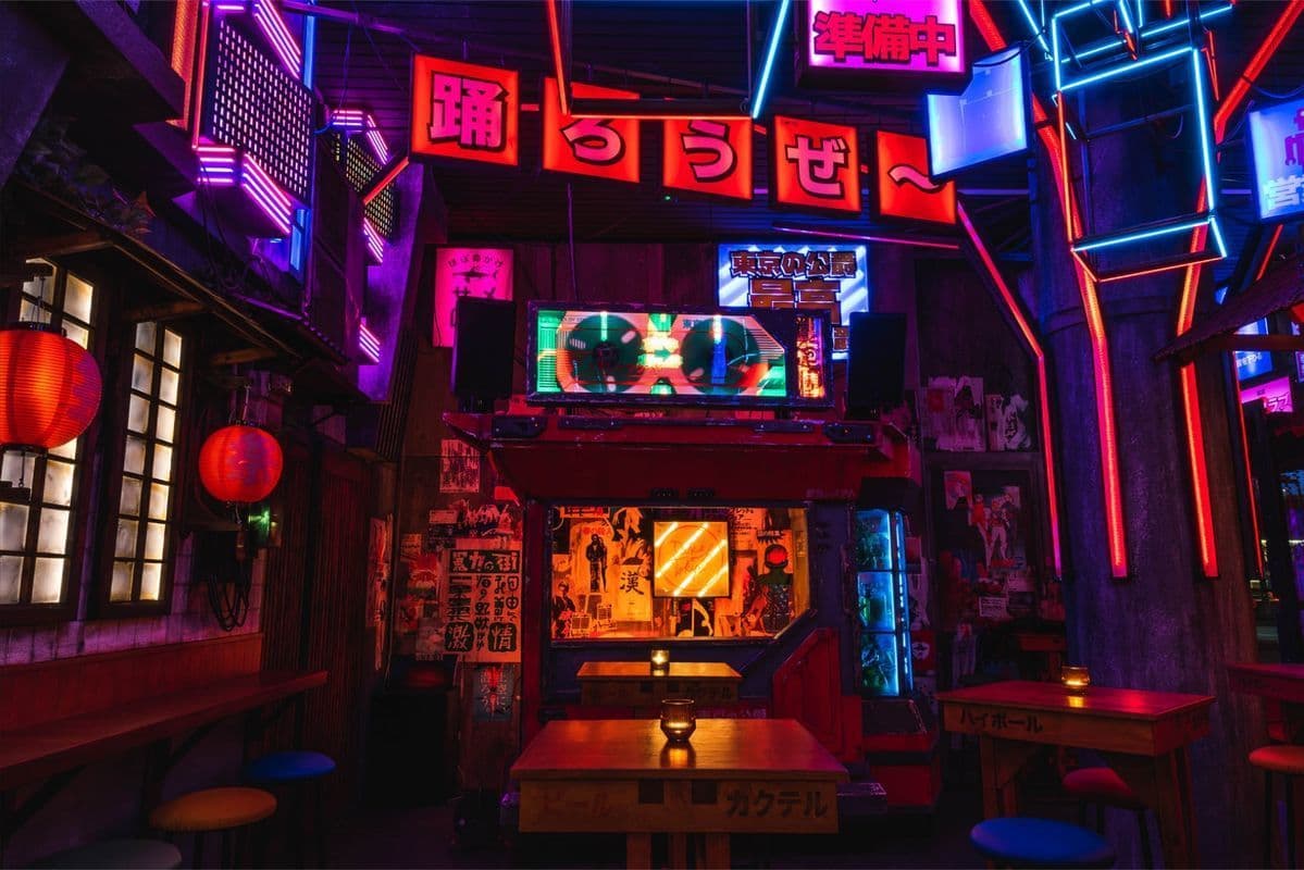 The bar's stage under layers of neon signage and lanterns